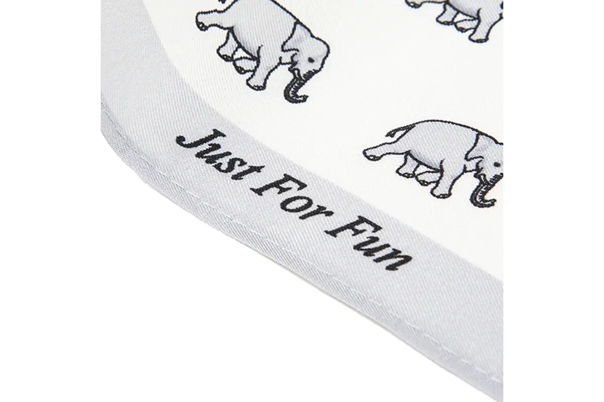 White fabric with black outlined animal motifs and lettering along the tie edge.