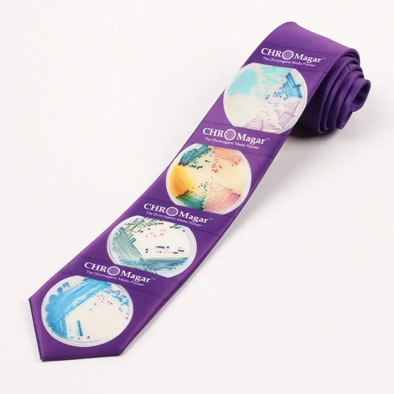 Purple tie with repeated circular full-color graphics and white brand lettering.
