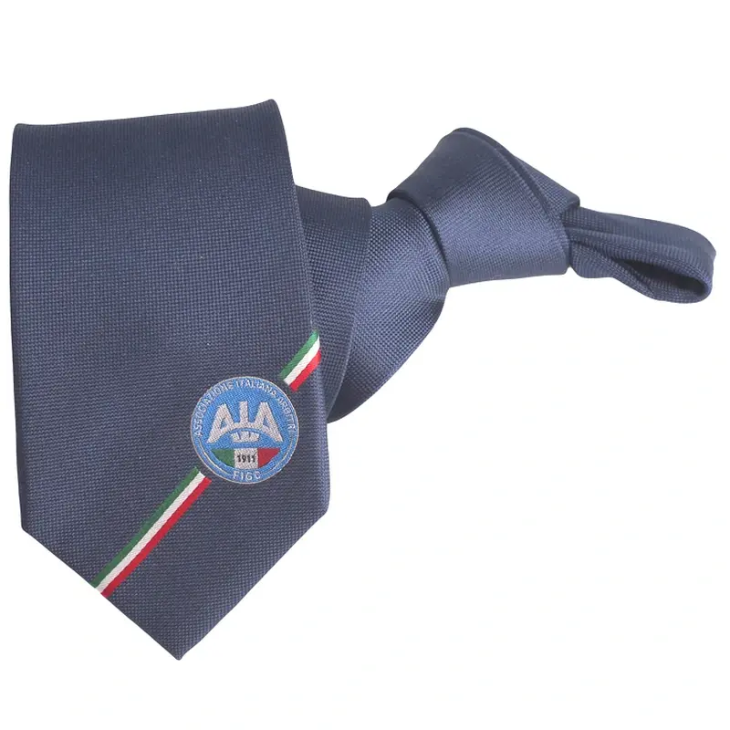 Dark blue knotted tie with a circular emblem and a narrow tricolor stripe.