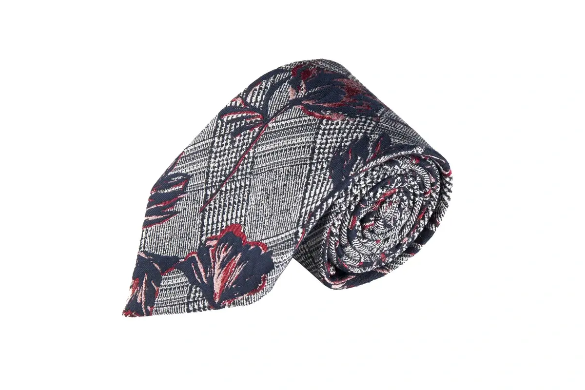 Rolled tie combining pink floral artwork with fine black and white check.