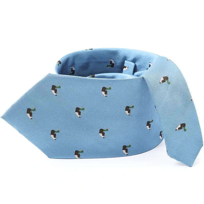 Light blue tie with small repeated animal motifs on the curved blade.