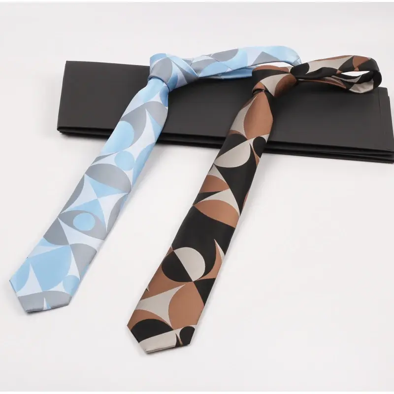 Blue and brown geometric patterned ties arranged over a black presentation box.