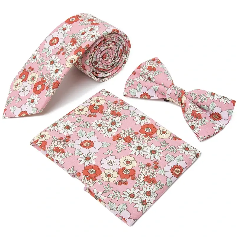 Pink floral necktie with a matching bow tie and pocket square.