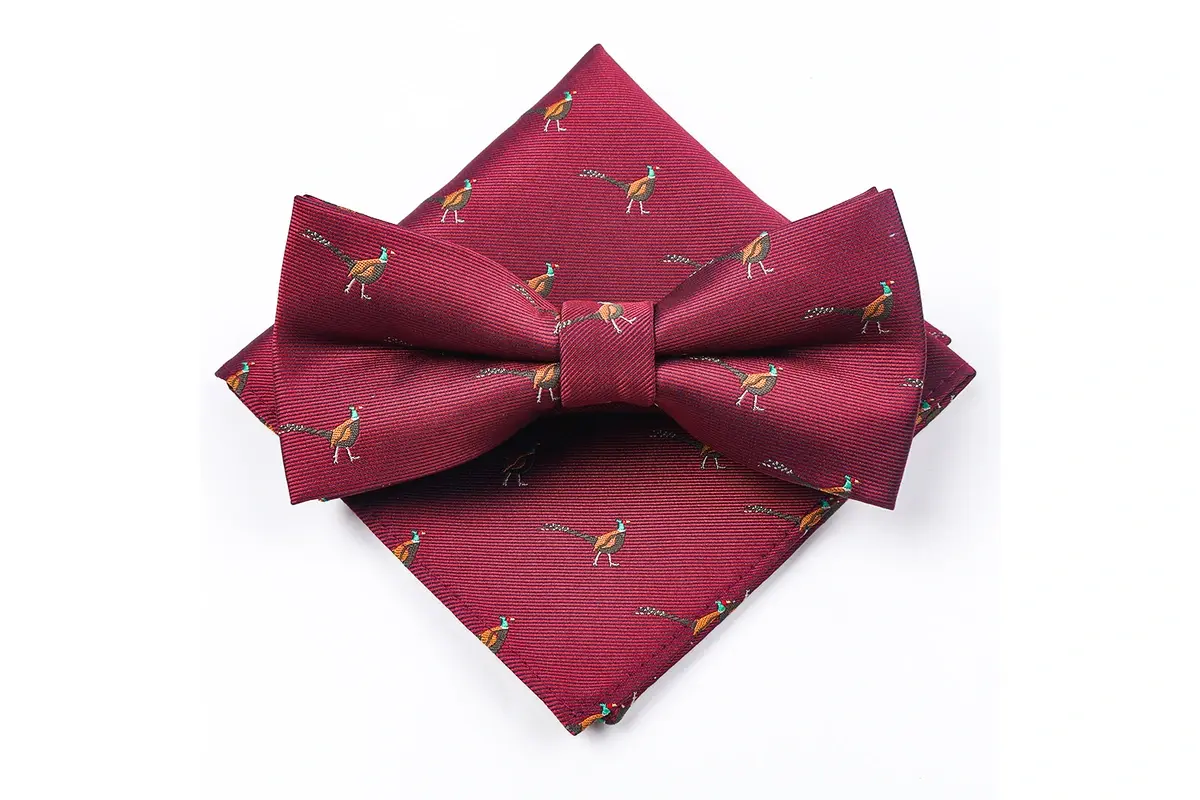 Burgundy pre-tied bow tie and coordinated pocket square with repeated animal.