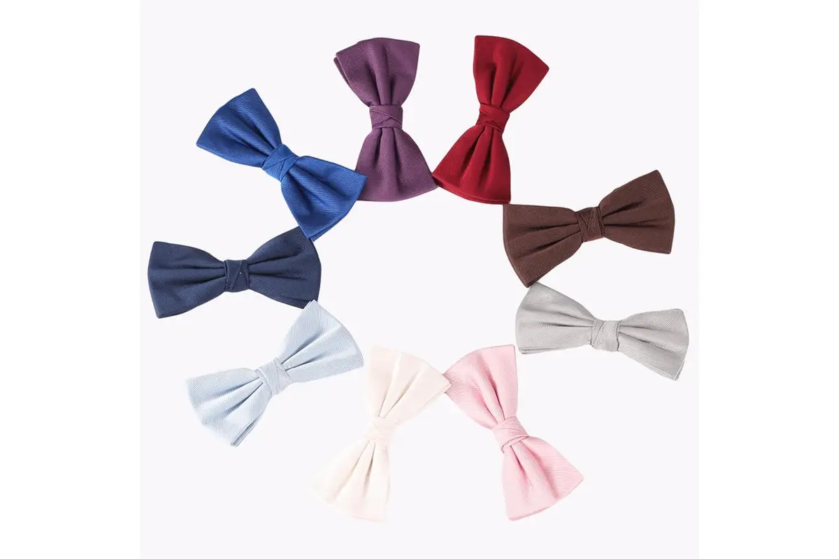 Eight pre-tied bow ties in blue, purple, red, brown, gray, white and pink.