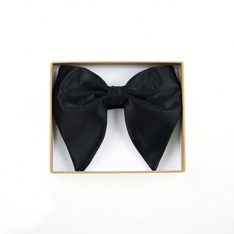 Black pointed bow tie displayed inside a kraft presentation box.
