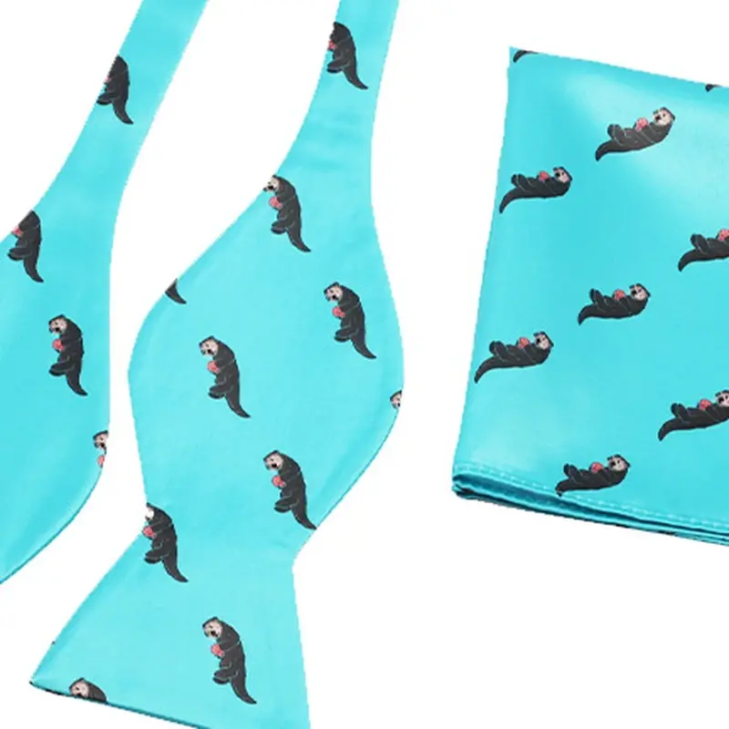 turquoise self-tie bow tie and matching pocket square with small motifs.