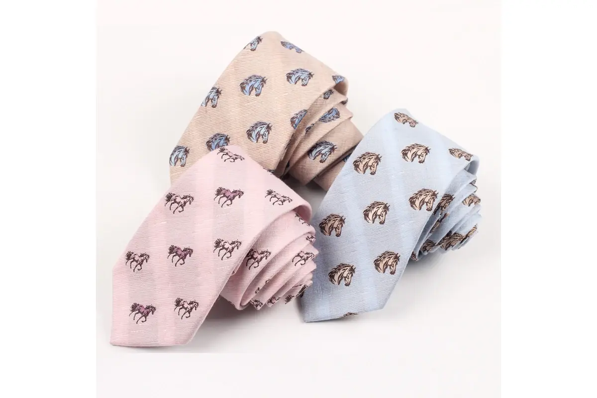 Beige, pink and pale blue ties with horse motifs for comparing colorways.