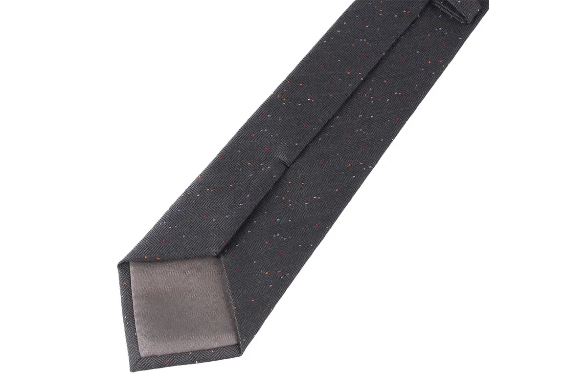 Dark tie reverse showing the center seam, keeper and contrasting tipping.