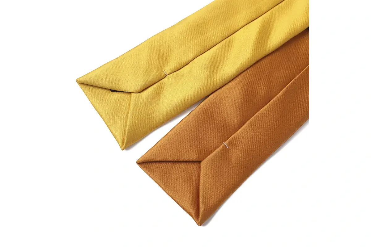 Reverse sides of yellow and gold ties with folded edges.