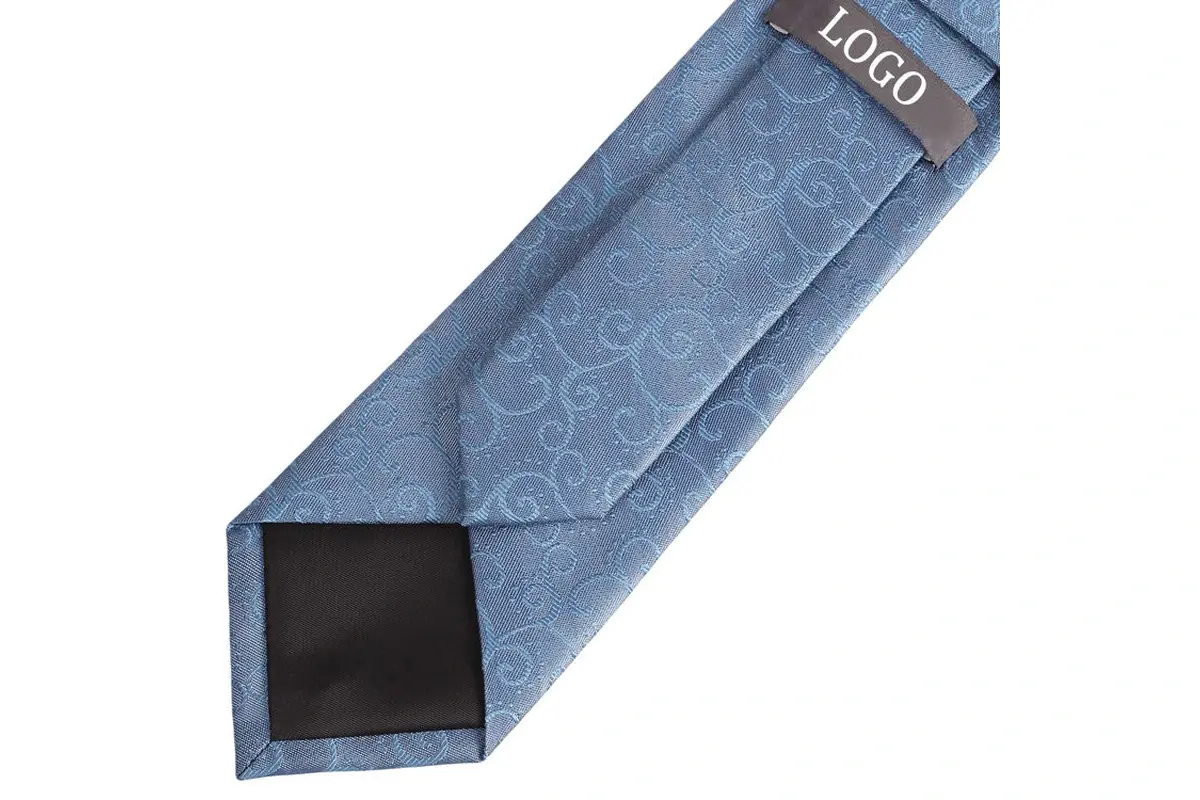 Blue patterned tie reverse with a sample label, center seam and black tipping.
