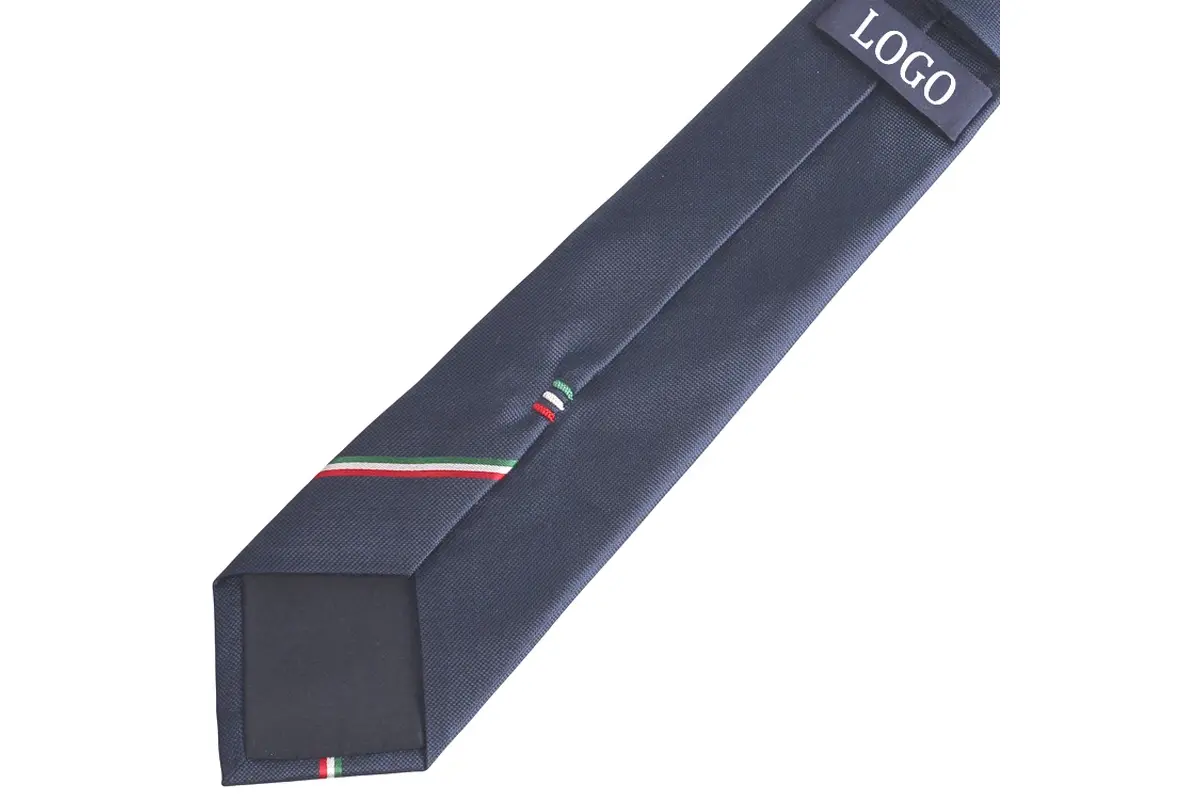Navy tie reverse with a label, center seam, dark tipping and patterned tail.