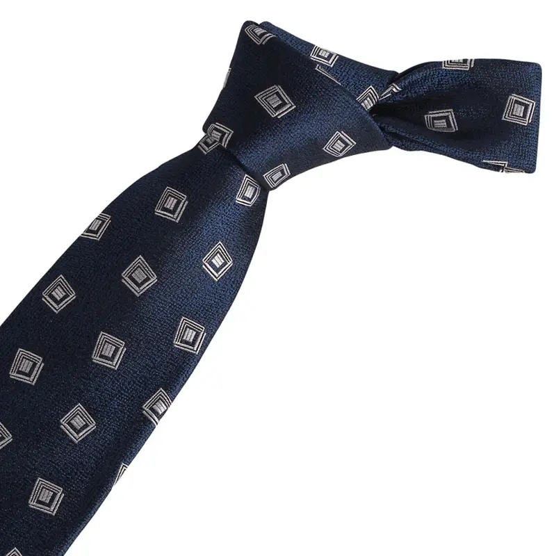 Knotted navy tie with repeated pale square emblems.