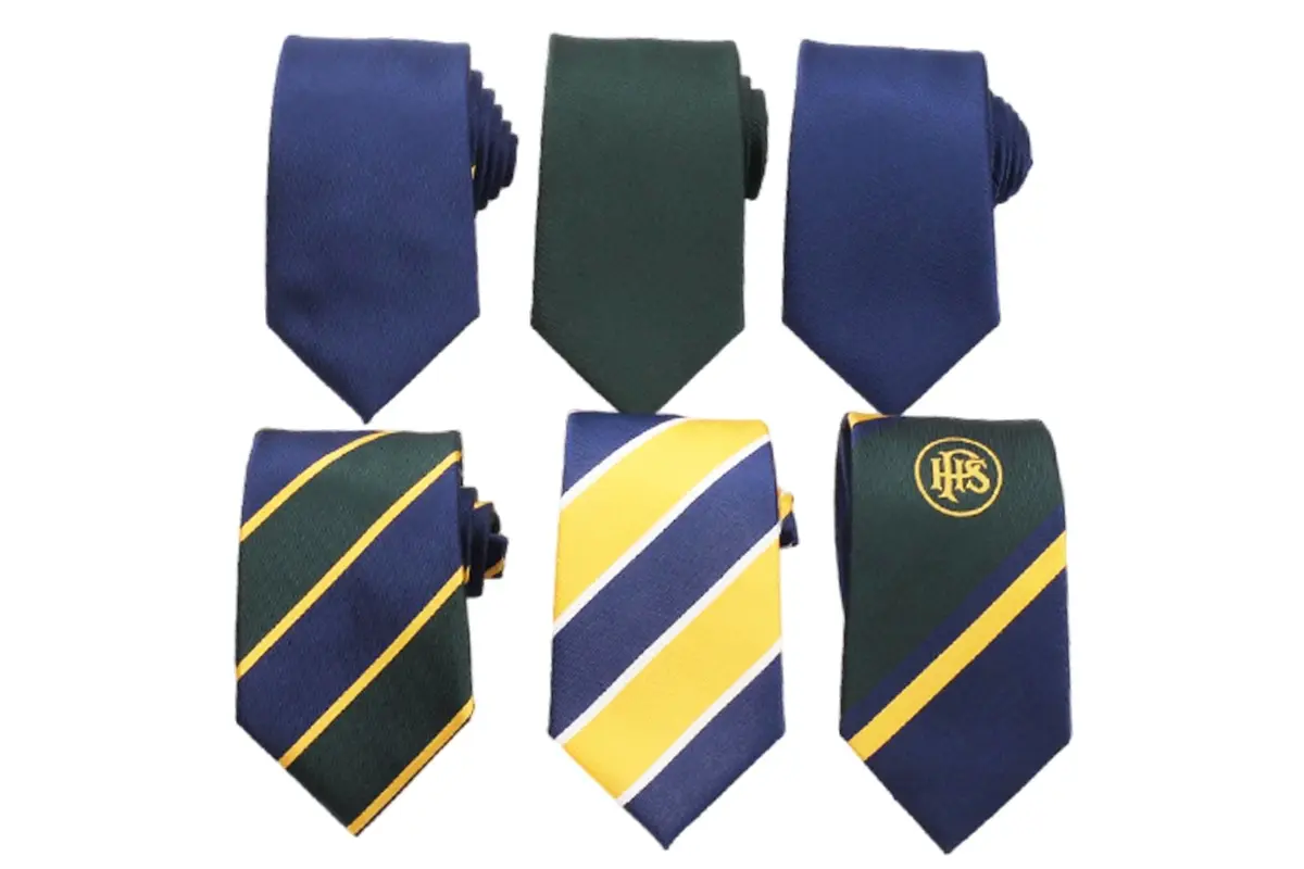 Six navy, green and yellow ties with diagonal stripes and circular crests.
