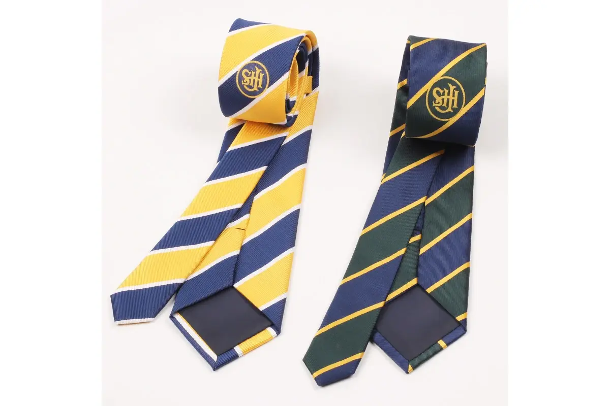 Two yellow and navy striped ties with monograms and dark reverse sides.