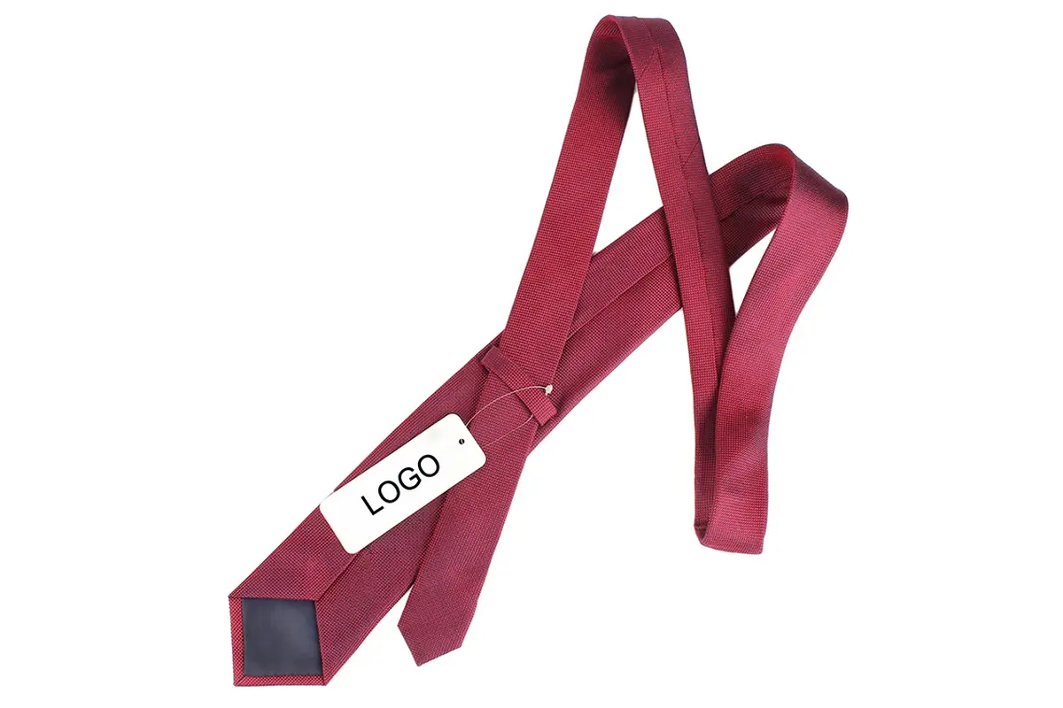Burgundy tie reverse with a white sample label, center seam and dark tipping.