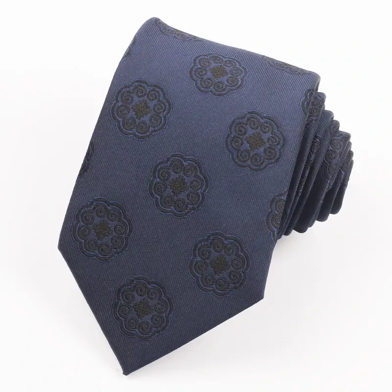 Rolled navy tie with repeated dark circular emblems.
