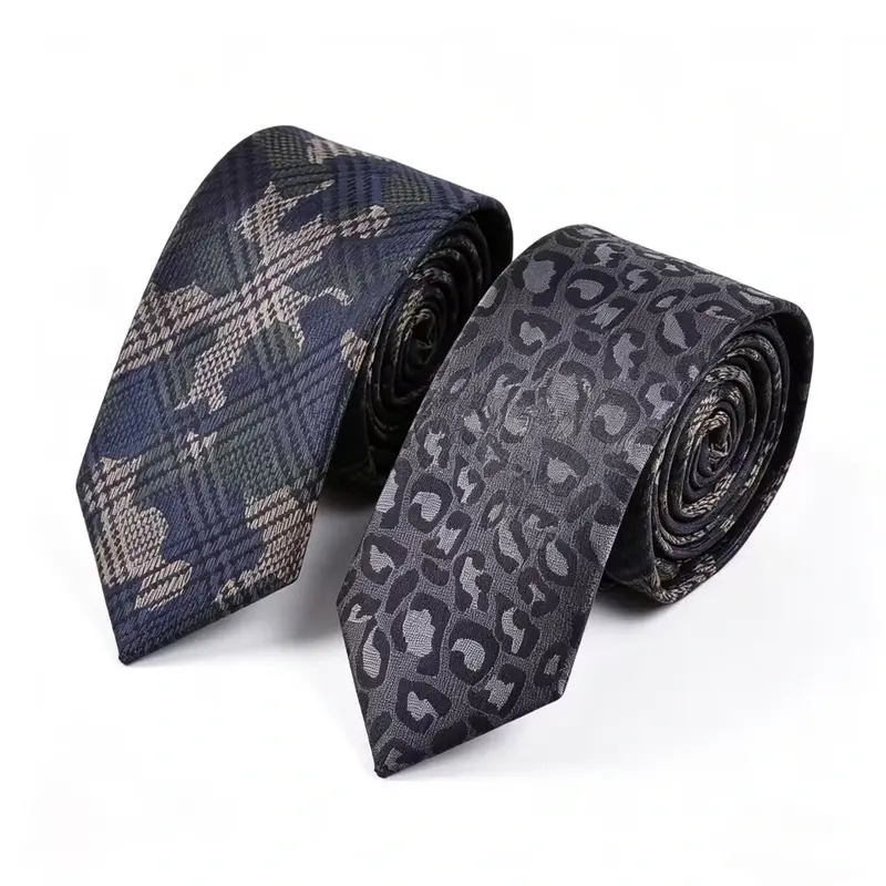 Two rolled ties showing a check pattern and a dark paisley pattern.