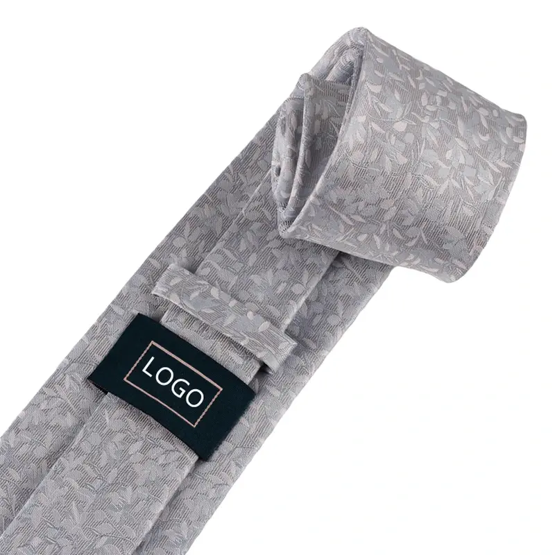 Grey floral tie with a black sample logo label on the reverse.