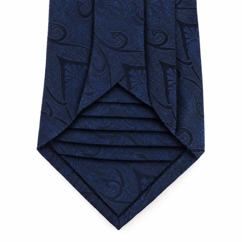 Open navy paisley tie blade showing the layered seven-fold construction.