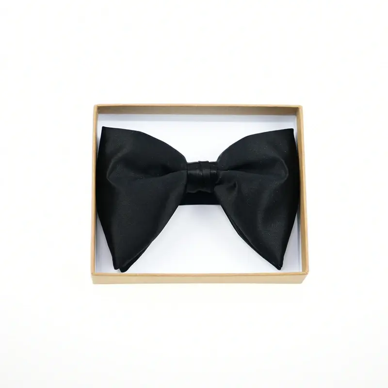 Black bow tie displayed inside a kraft presentation box.