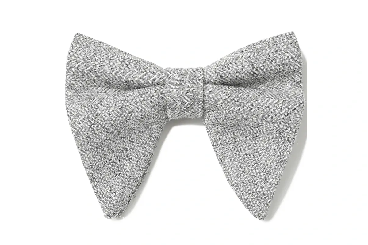 Gray bow tie with a textured herringbone pattern and pointed wings.