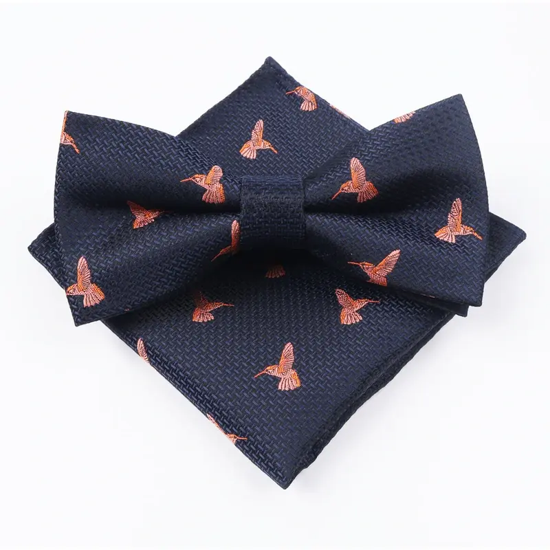 Navy bow tie and matching pocket square with repeated orange motifs.