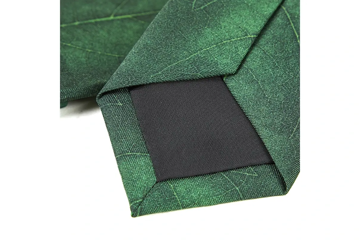 Green tie reverse showing folded edges, stitching and dark tipping.