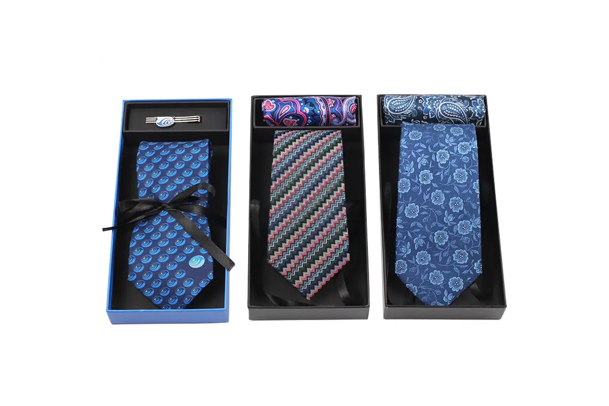 Three patterned ties arranged in individual presentation boxes.