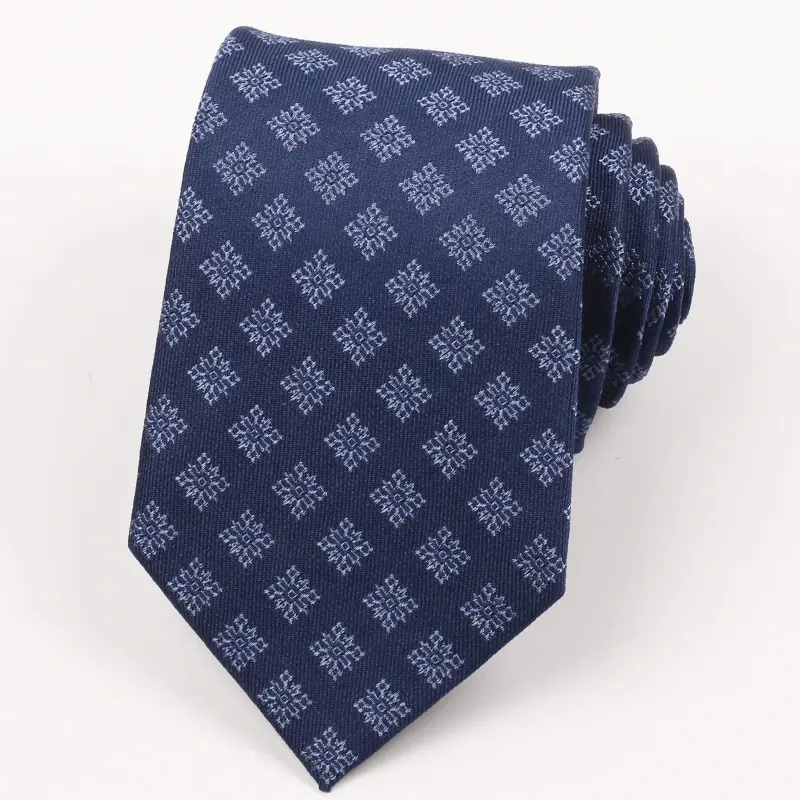 Navy tie with pale repeating woven geometric motifs.