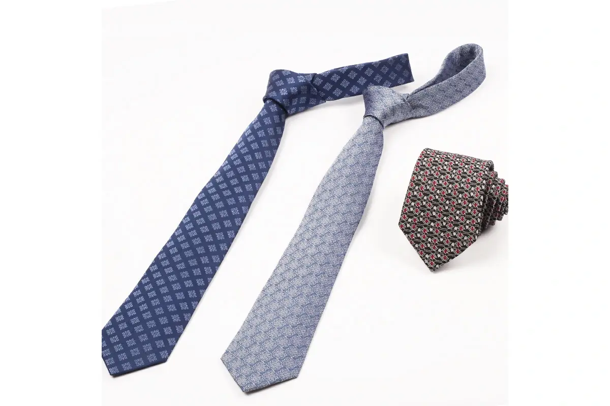 Three patterned ties showing blade shapes and knot proportions.
