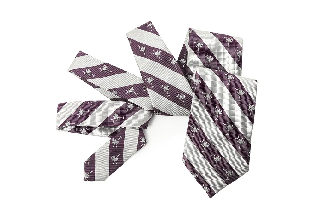 Purple and ivory striped ties with repeated woven palm motifs.