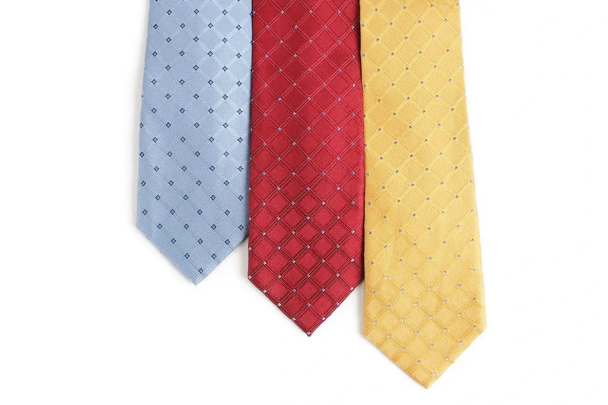 Light blue, red and yellow ties with repeating diamond motifs.