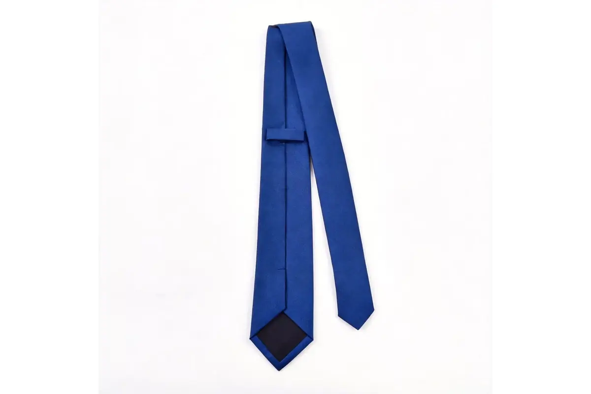 Plain blue tie reverse showing the keeper loop, center seam and dark tipping.