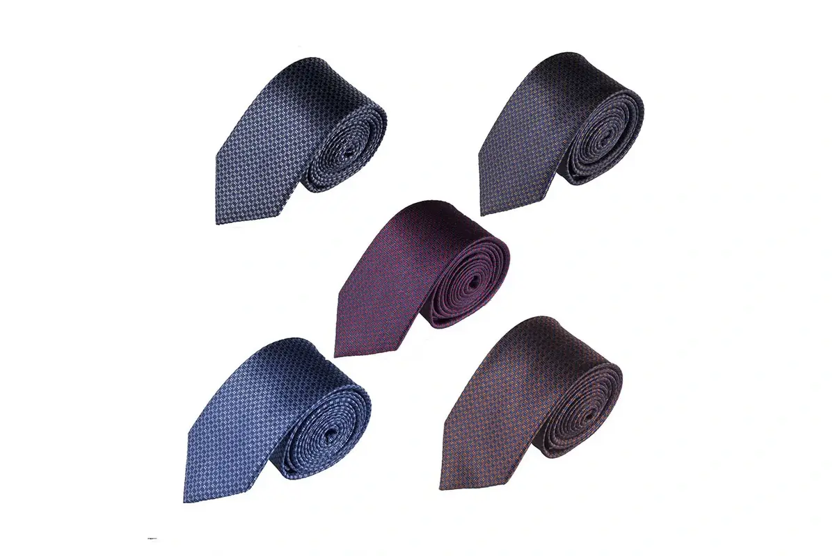 Five rolled textured ties in muted blue, gray, purple and brown shades.