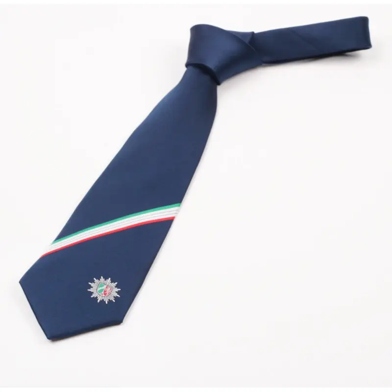 Knotted navy tie with an emblem below a green, white and red stripe.