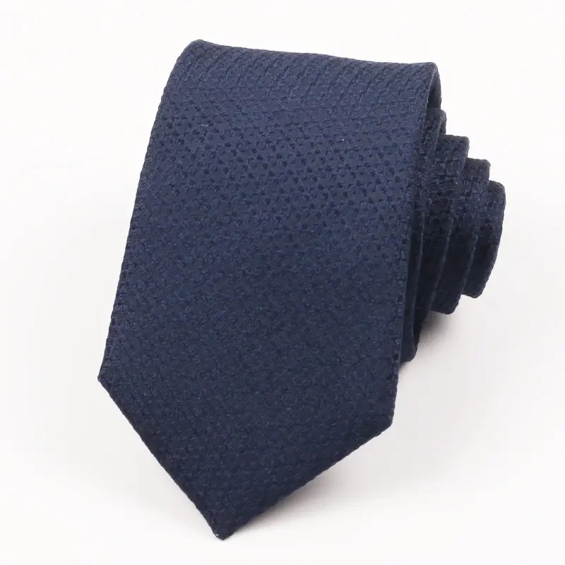 Rolled navy necktie on white background