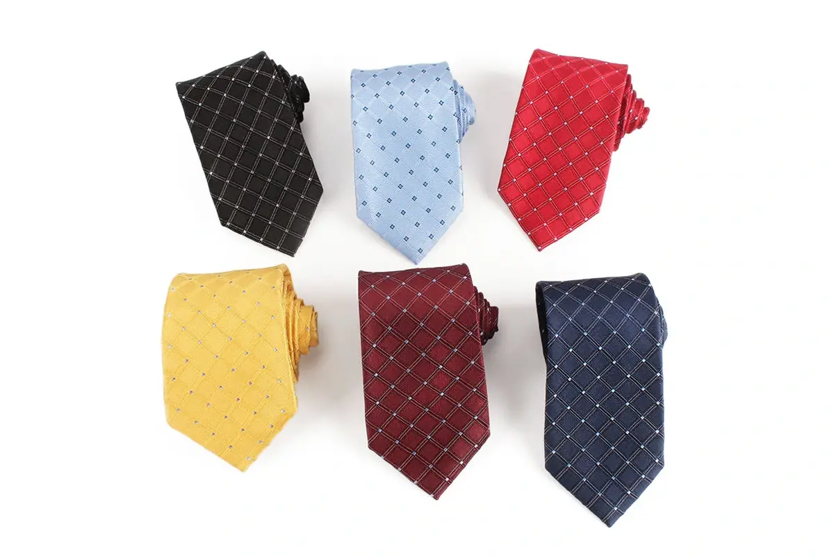 Six folded ties with shared fine grid pattern in black, pale blue, red, yellow.