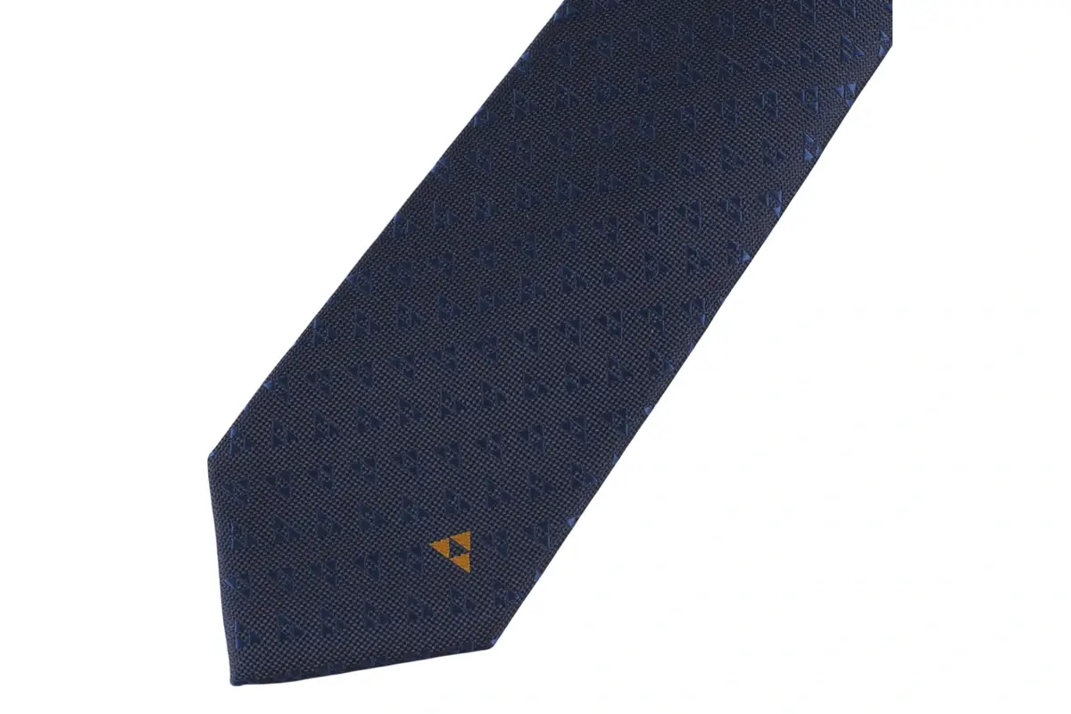 Navy tie blade with a small gold geometric mark near the tip.