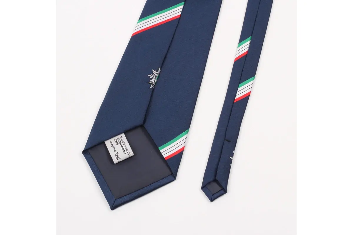 A navy tie with white care label, dark tipping and green, white and red stripes.