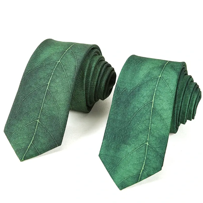 Two green rolled ties with subtle diagonal lines.