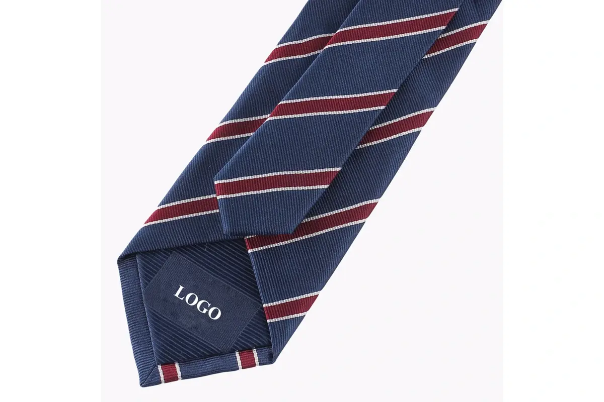Navy tie reverse with burgundy and pale stripes and sample on the tipping.