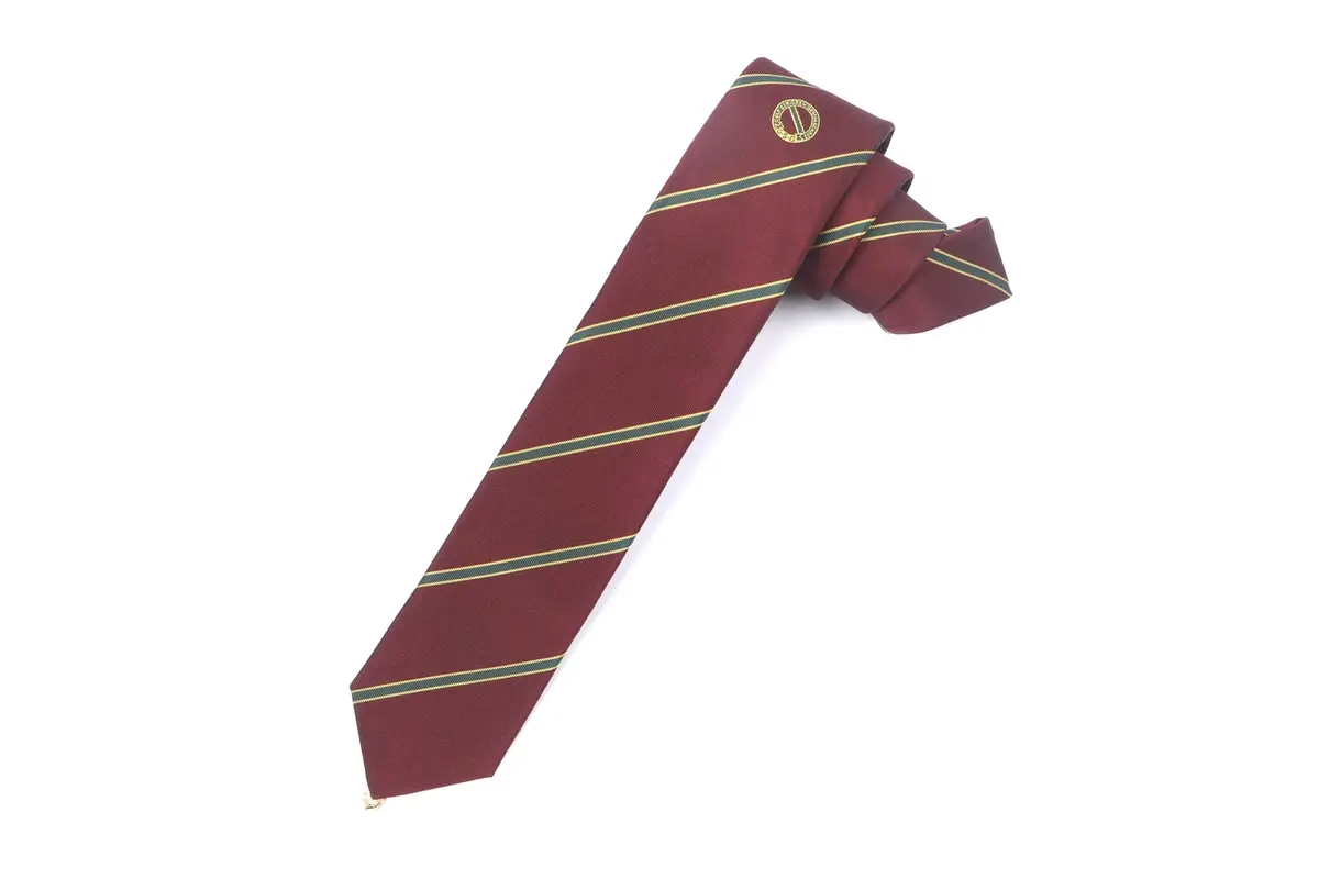 Burgundy tie with green and gold stripes and a small circular emblem.