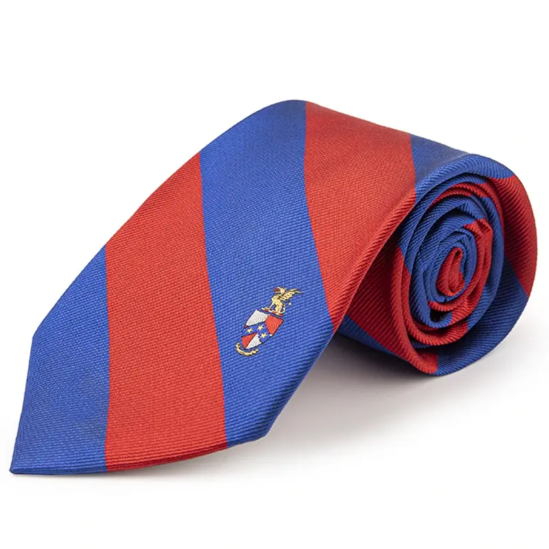 Rolled red and blue striped tie with a small multicolor crest on the blade.