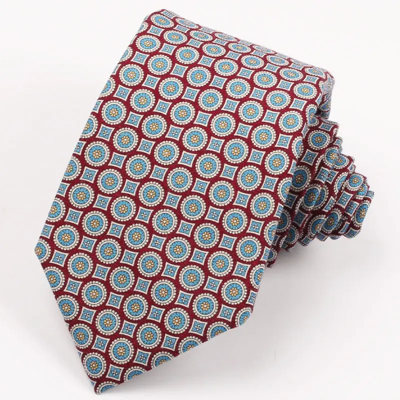 Rolled tie with repeating red, blue and white circular motifs.