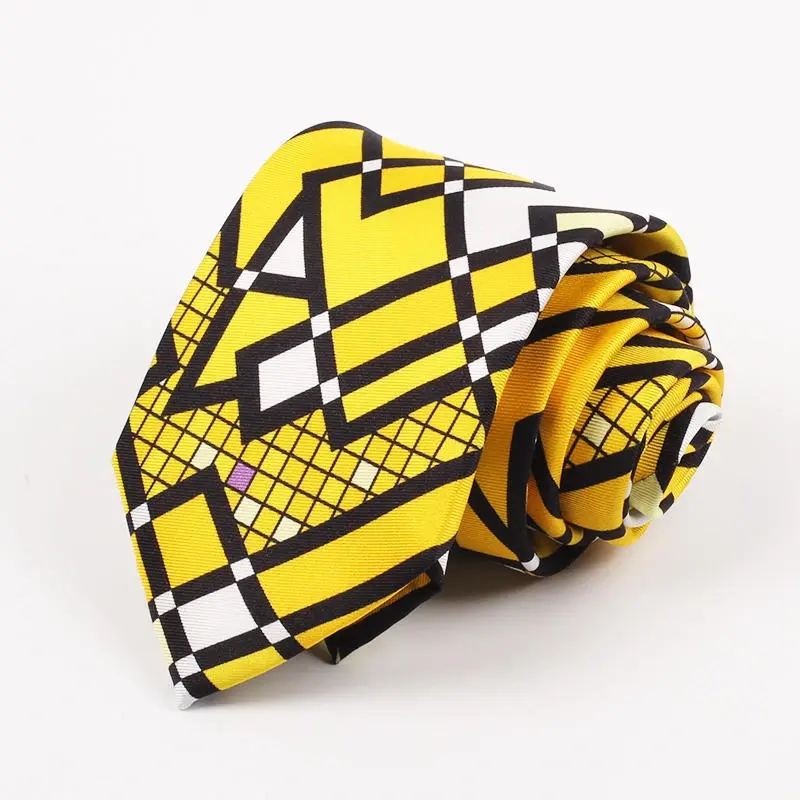 Rolled yellow tie with bold black and white geometric lines and shapes.