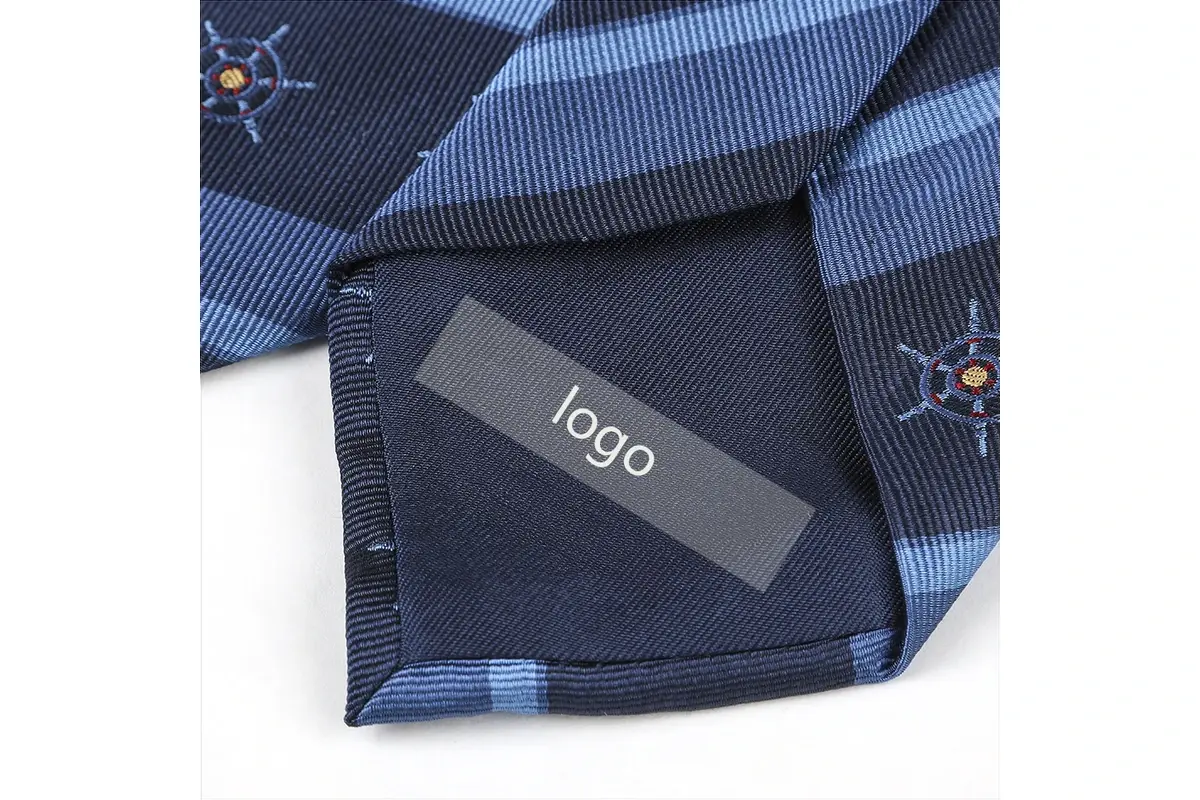 Blue striped tie reverse with a rectangular sample logo label on dark tipping.