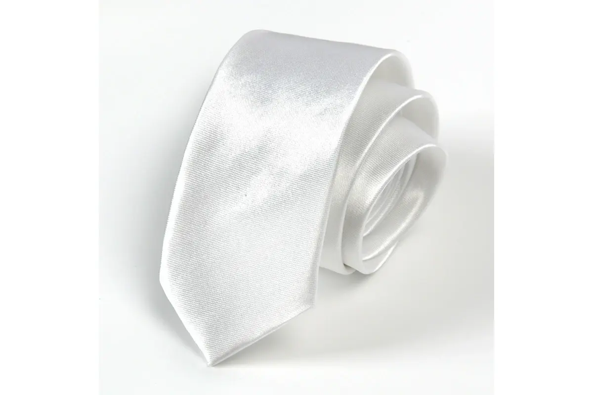 Rolled white tie showing a plain light-colored surface and tapered blade.