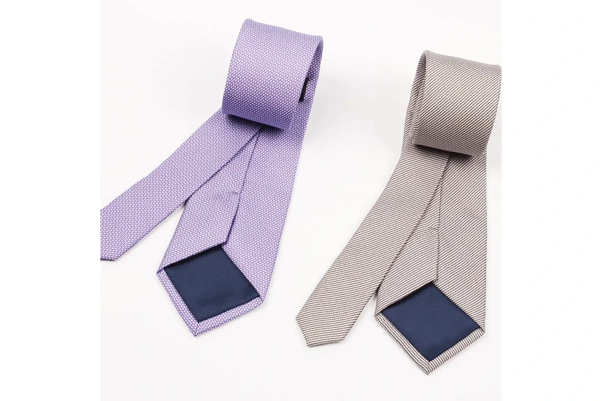 Lavender and taupe ties with the front blades, narrow tails and reverse tipping.