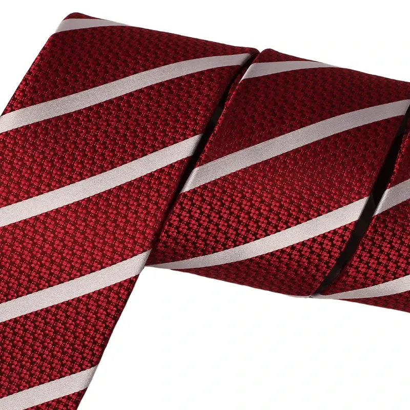 Close-up of burgundy necktie with diagonal white stripes